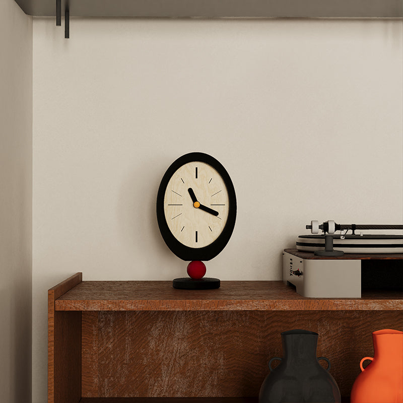 Minimalist retro desktop clock in oval wood with a playful red sphere base — view 3