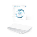Natural eco friendly laundry detergent sheets in fresh linen scent arranged next to clean folded clothes