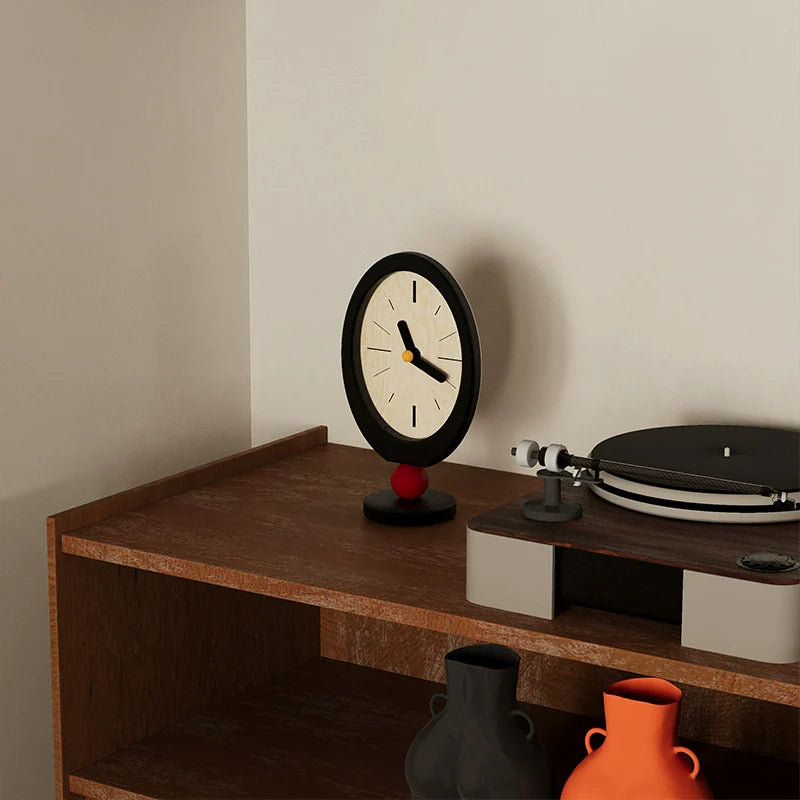 Minimalist retro desktop clock in oval wood with a playful red sphere base — view 4