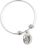 Stainless steel Saint Benedict medal snake chain charm bracelet on a neutral background