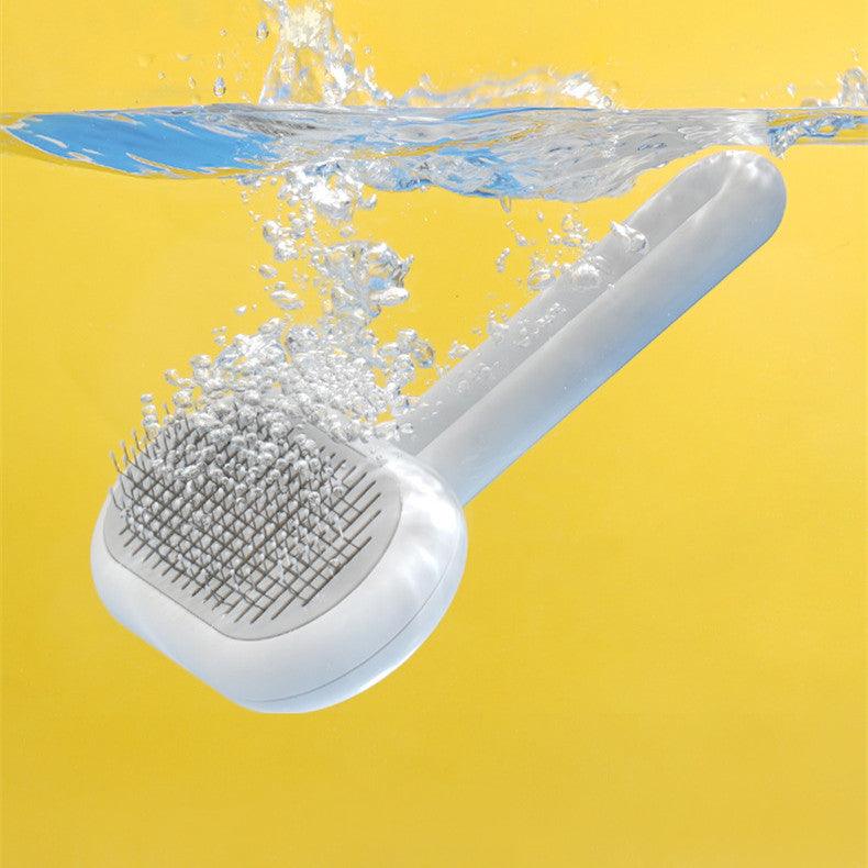 Ergonomic pet grooming comb with stainless steel bristles and a sleek capsule shape handle — view 3