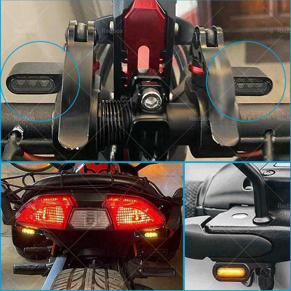 Two black aluminum mini LED motorcycle turn signals emitting bright amber blinker light. — view 4