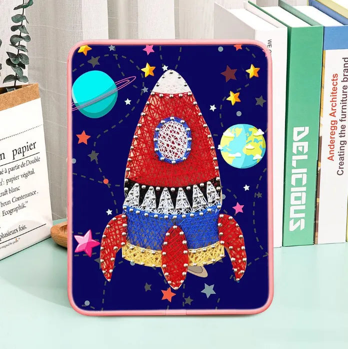 Rocket string art kit featuring colourful thread, metallic pins, and a sturdy wooden display stand.