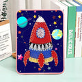 Rocket string art kit featuring colourful thread, metallic pins, and a sturdy wooden display stand.