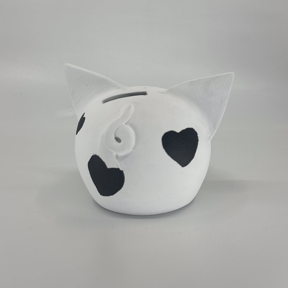 Queen of Hearts ceramic piggy bank in white with hand-painted black heart motifs and cork snout — view 2