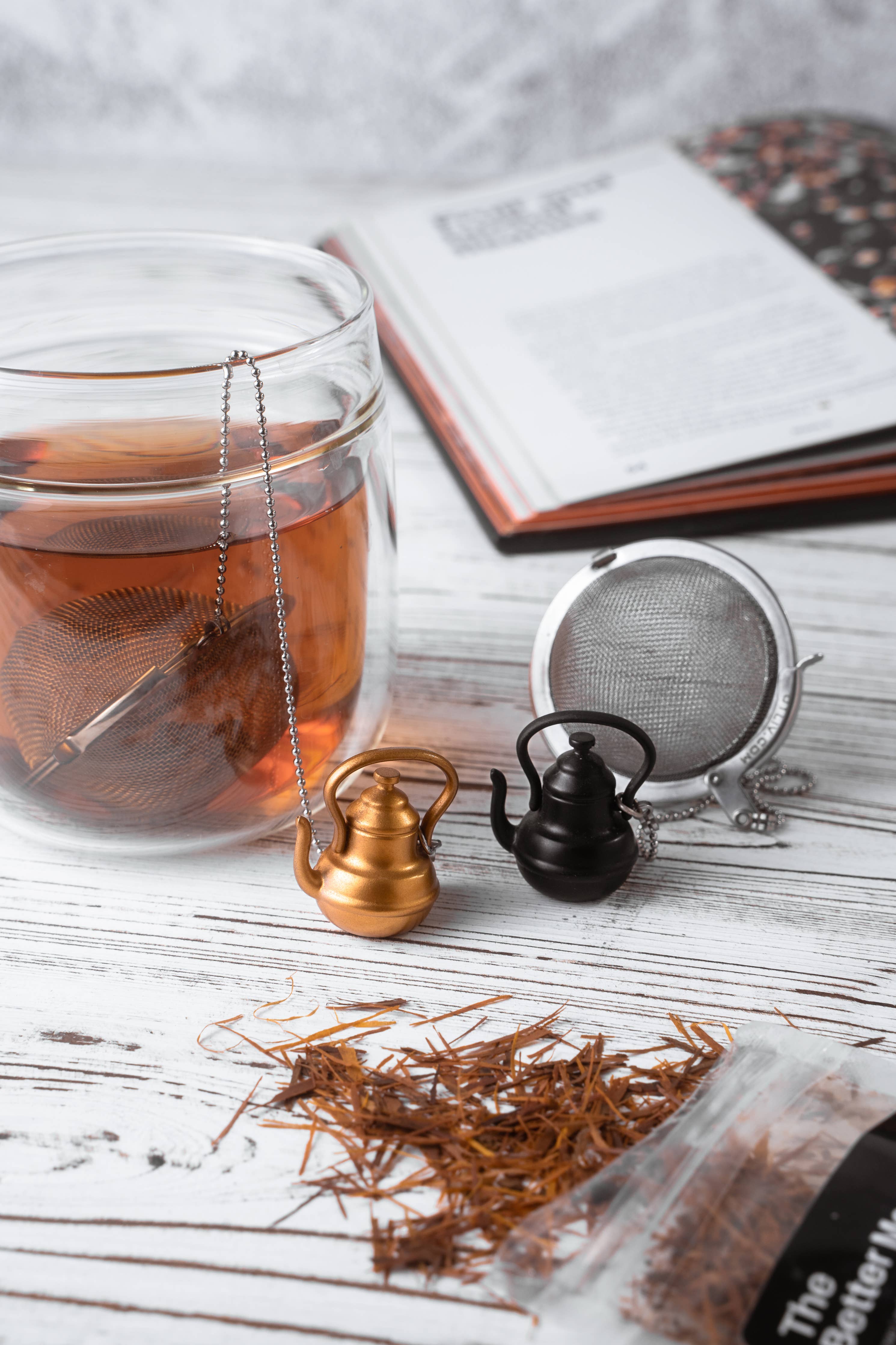Stainless steel mesh tea infuser ball with a decorative gold teapot charm and metal chain — view 3