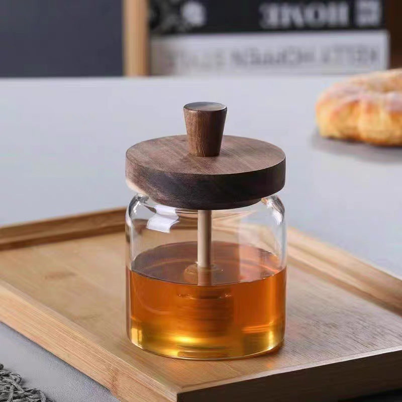 Clear high borosilicate glass honey jar with a natural wooden lid and built in dipper