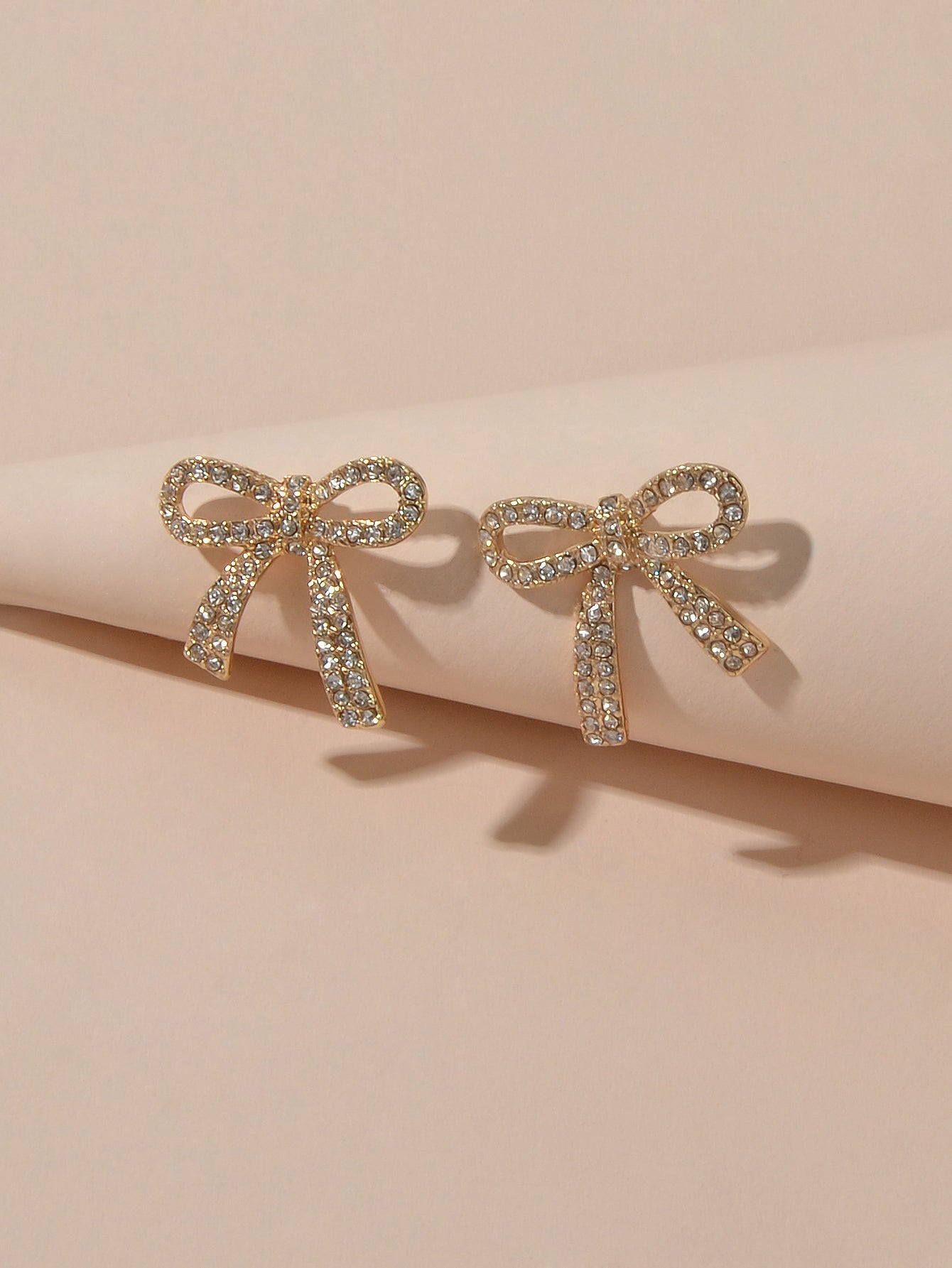Sparkly rhinestone bow-knot stud earrings with a gold plated finish for elegant party wear. — view 4