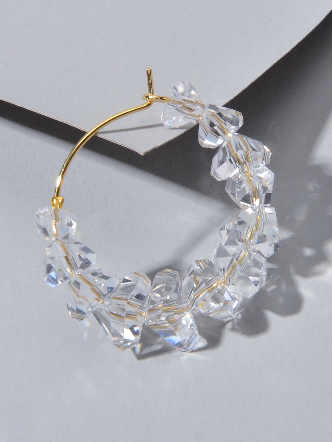 Transparent acrylic bead hoop dangle earrings for women on a clean background. — view 4
