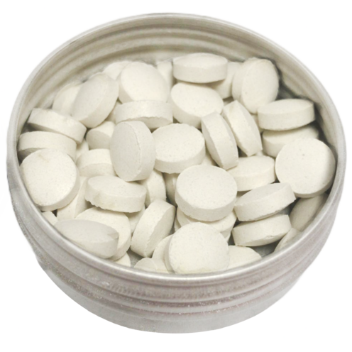 Fresh peppermint toothpaste tablets in a reusable tin container for zero waste oral care