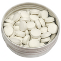 Fresh peppermint toothpaste tablets in a reusable tin container for zero waste oral care