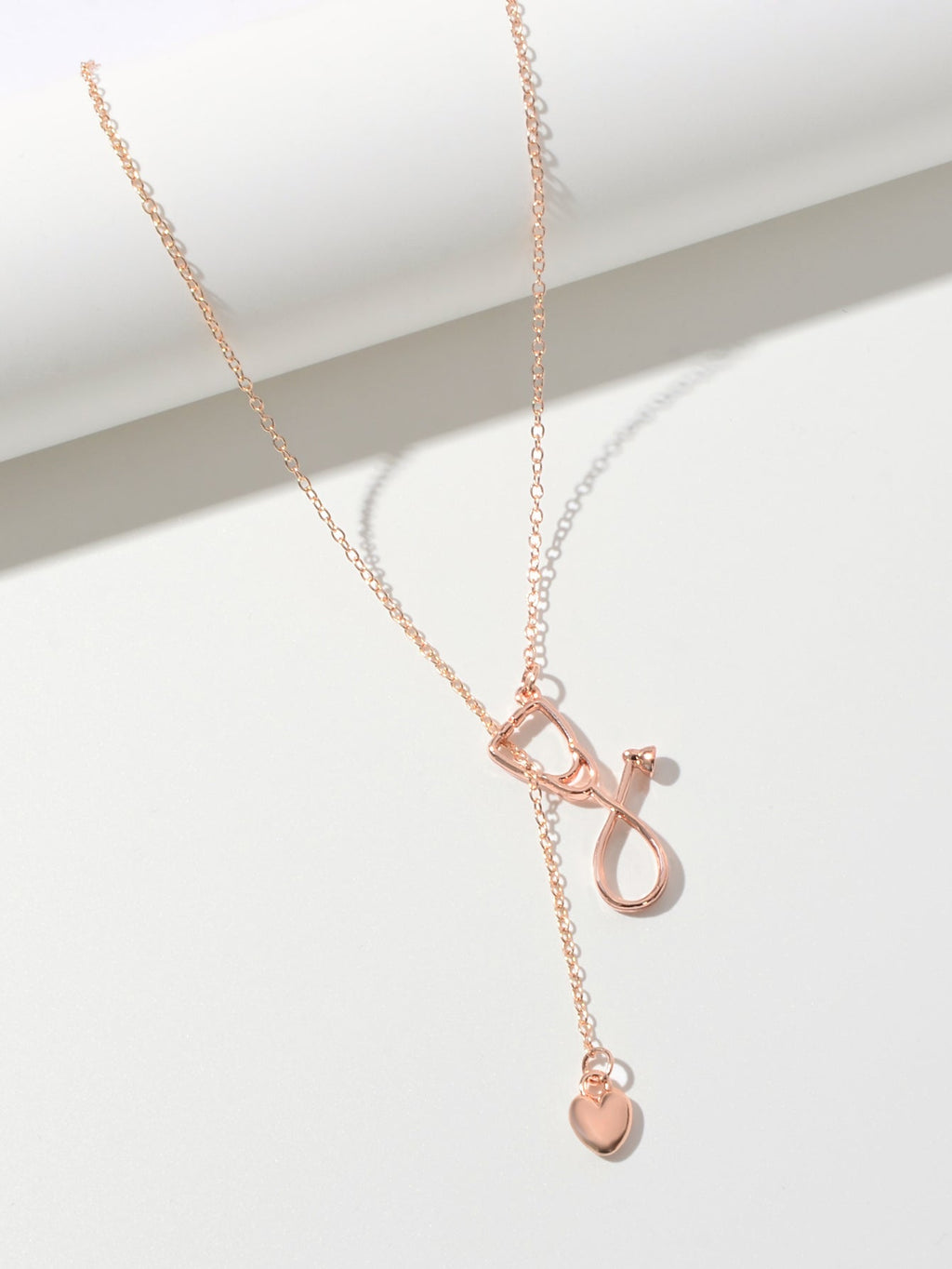 Minimalist gold and silver stethoscope heart pendant Y-shape necklace on a delicate chain — view 4