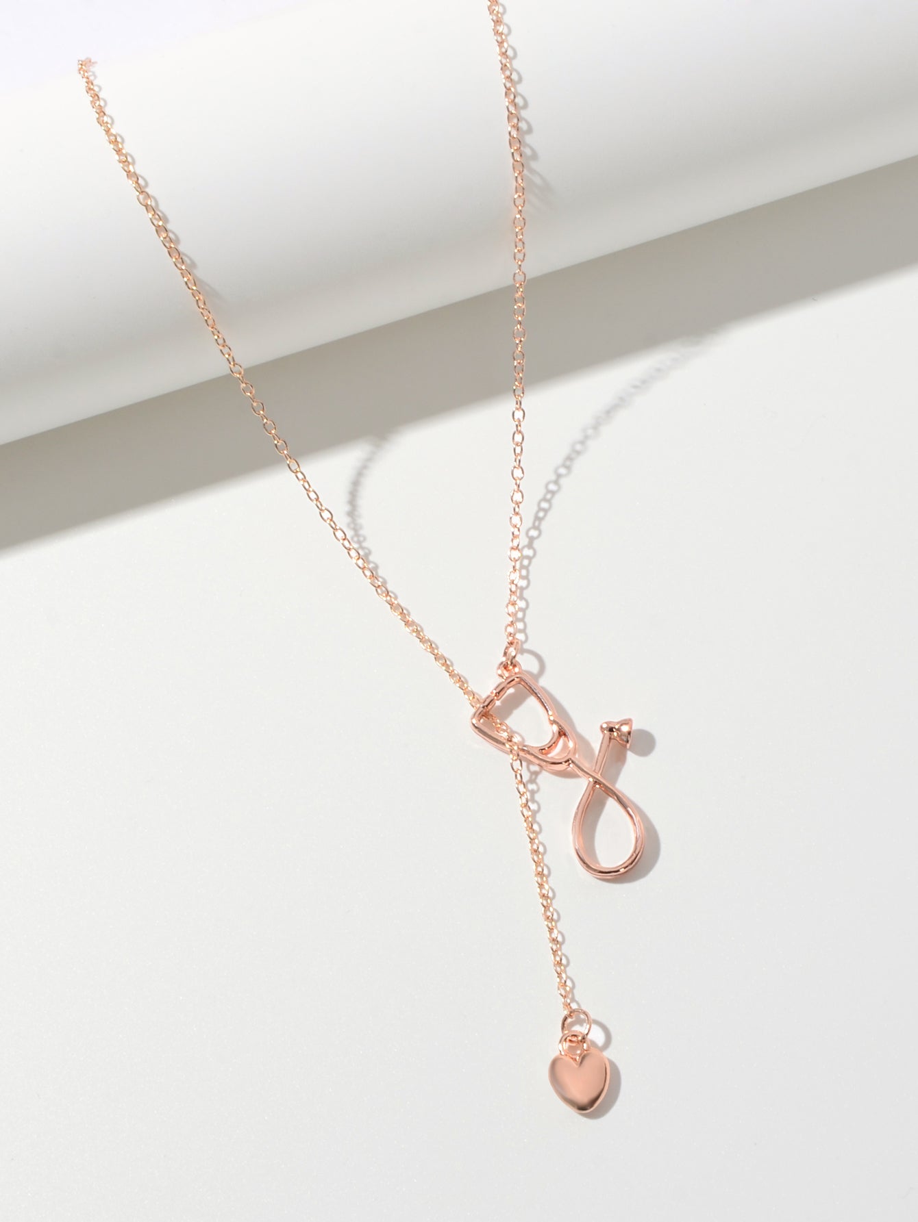 Minimalist gold and silver stethoscope heart pendant Y-shape necklace on a delicate chain — view 4