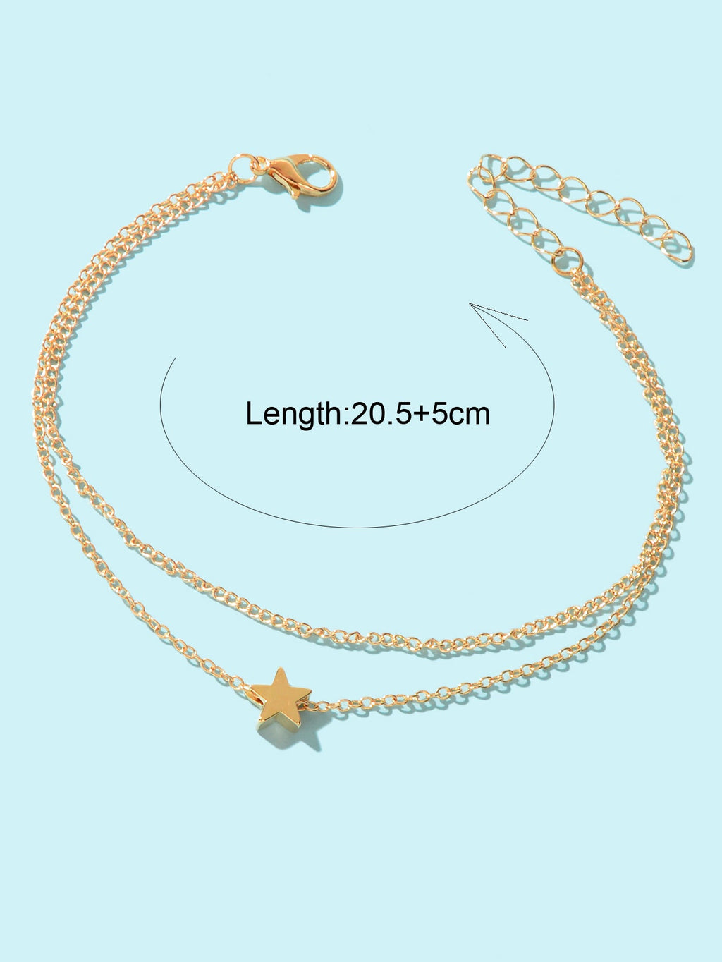Minimalist double layered gold chain anklet featuring delicate star charms on a plain background — view 4