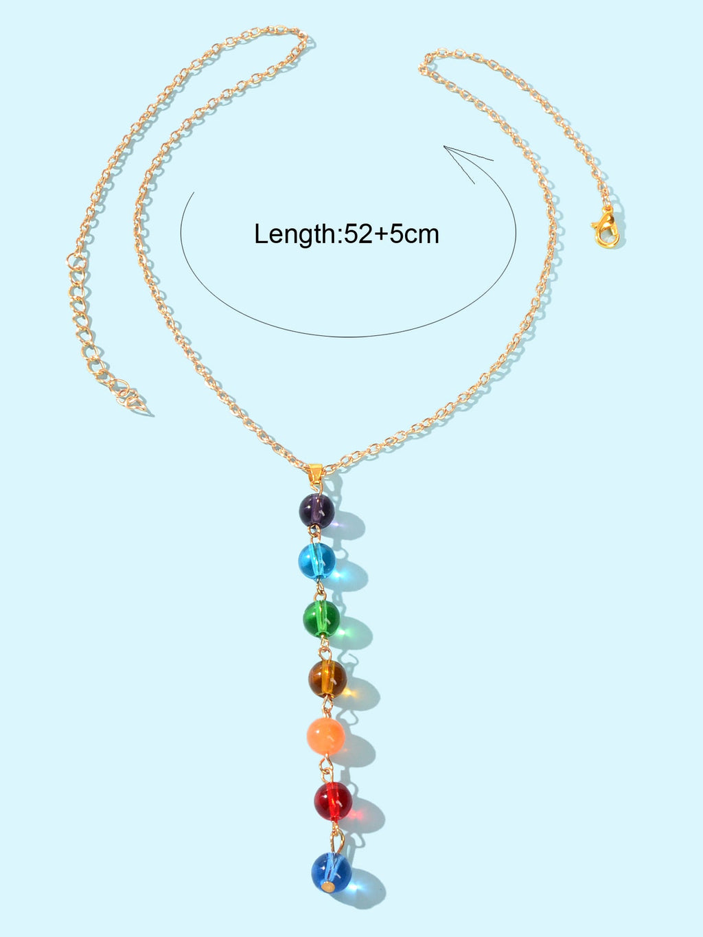 Dainty gold chain Y-shape lariat necklace with colorful glass beads on a female neckline — view 4