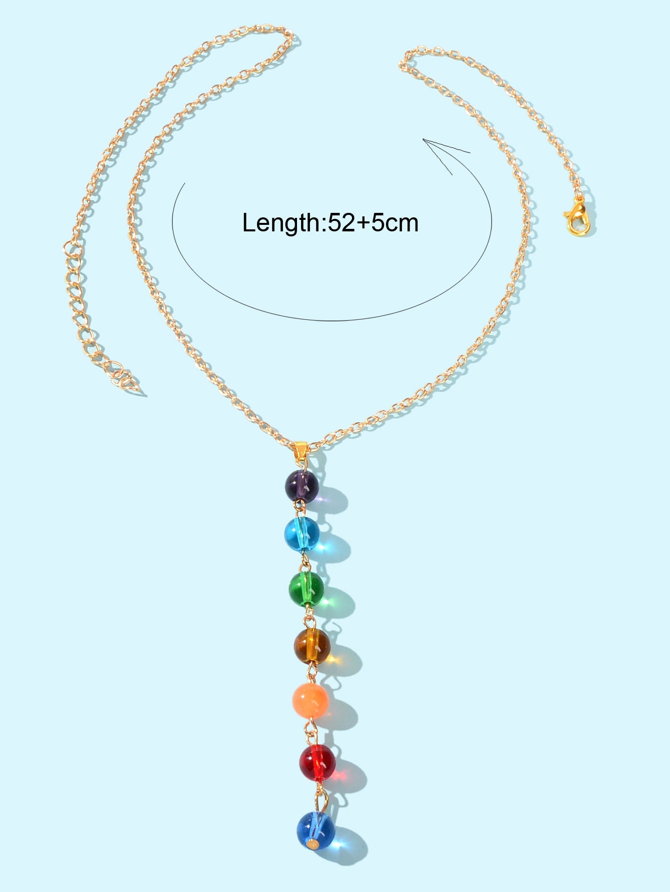 Dainty gold chain Y-shape lariat necklace with colorful glass beads on a female neckline — view 4