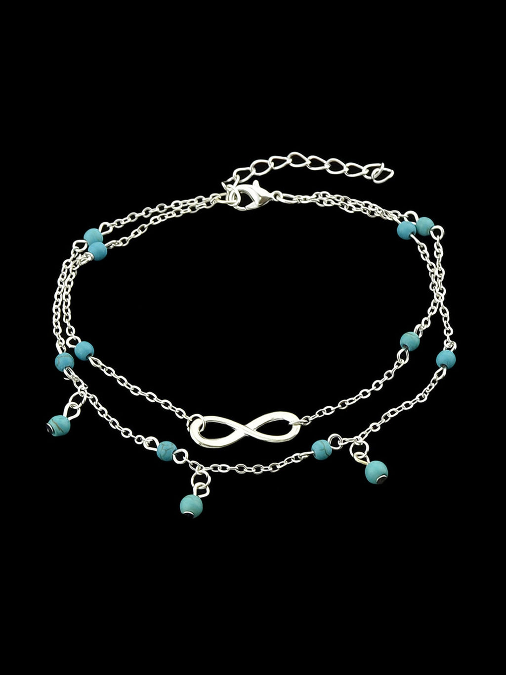 Turquoise infinity anklet with double layer silver chain worn on a bare foot. — view 4