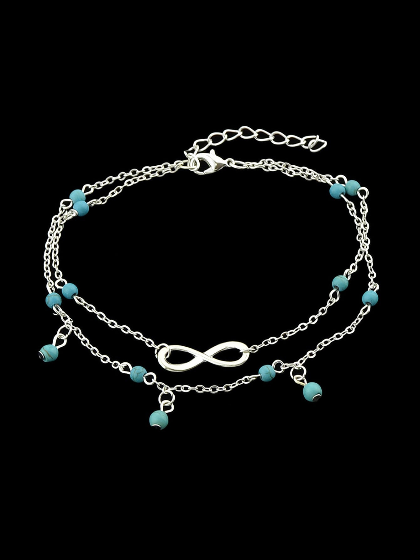 Turquoise infinity anklet with double layer silver chain worn on a bare foot. — view 4