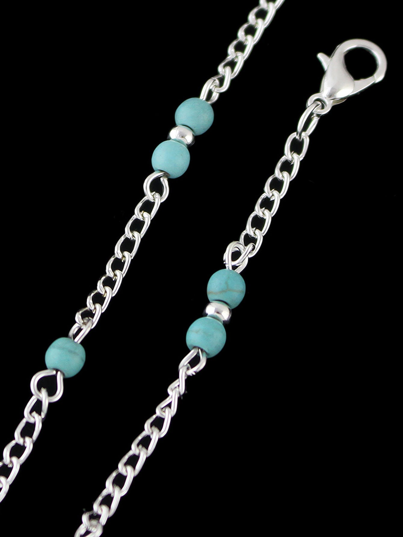 Boho chic turquoise barefoot sandal anklet with delicate silver chains draped gracefully over a foot — view 4