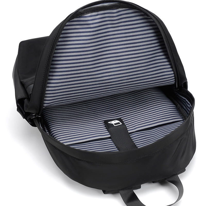 Minimalist black waterproof nylon laptop backpack with zippered pockets for urban commuting and travel — view 5