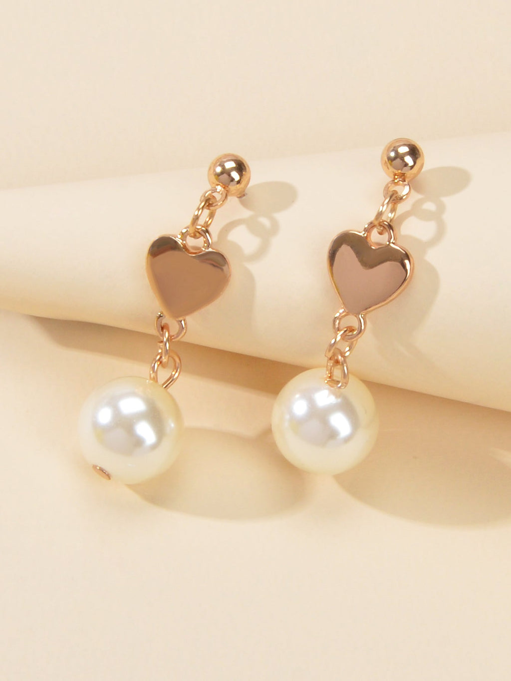Gold heart drop earrings with simulated pearls for weddings and anniversaries on a white background — view 4