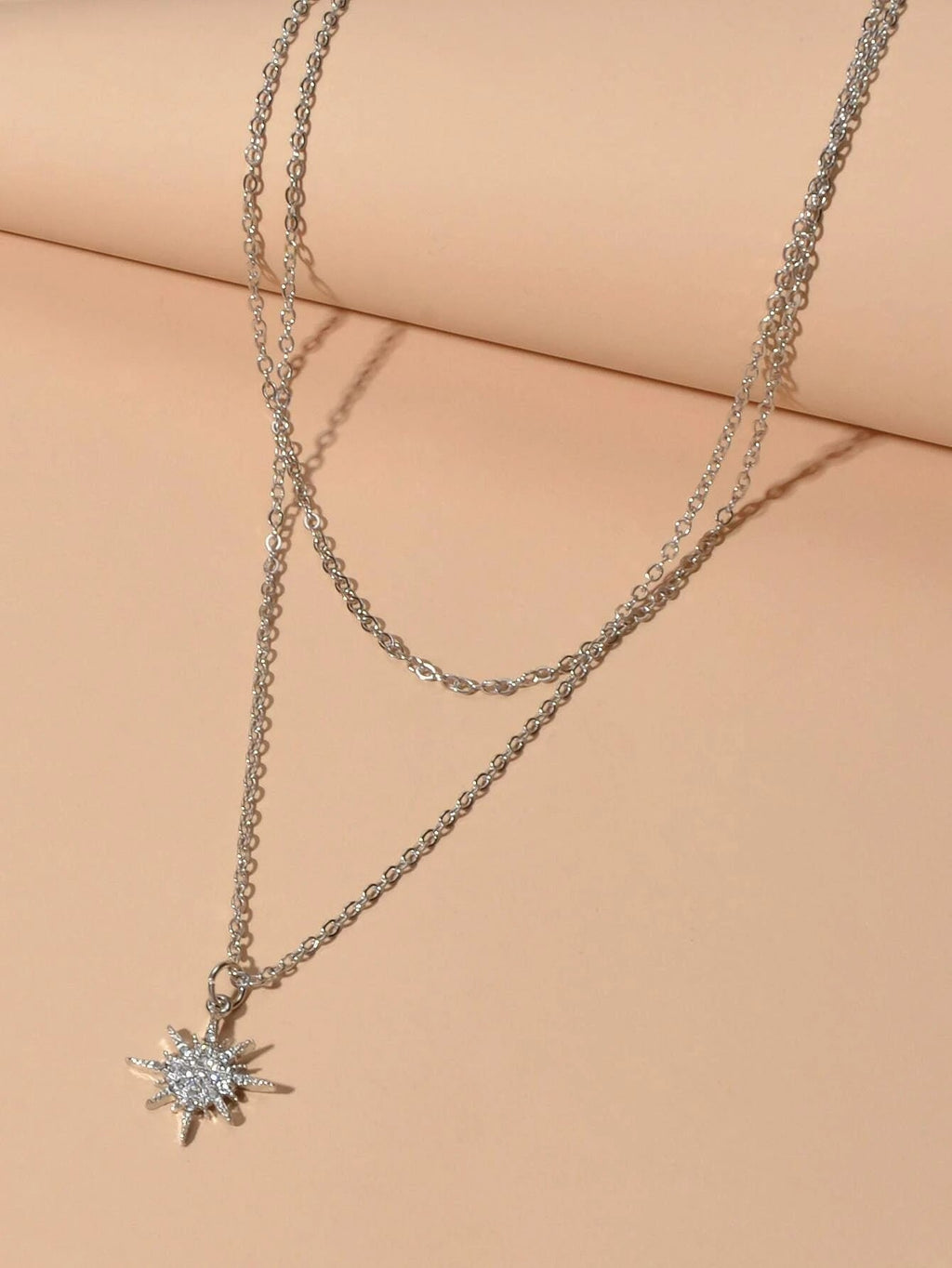 Silver double layer star pendant necklace and five matching knuckle rings displayed together as a set — view 4