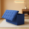 Navy blue folding storage ottoman bench with padded seat and hidden interior chest