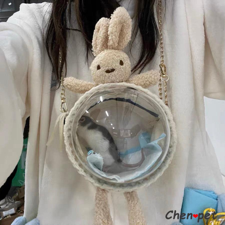Portable plastic hamster travel cage with ventilation holes and convenient pet carrying bag.