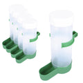 Automatic bird food dispenser in green and clear plastic mounted on a wire pet bird cage