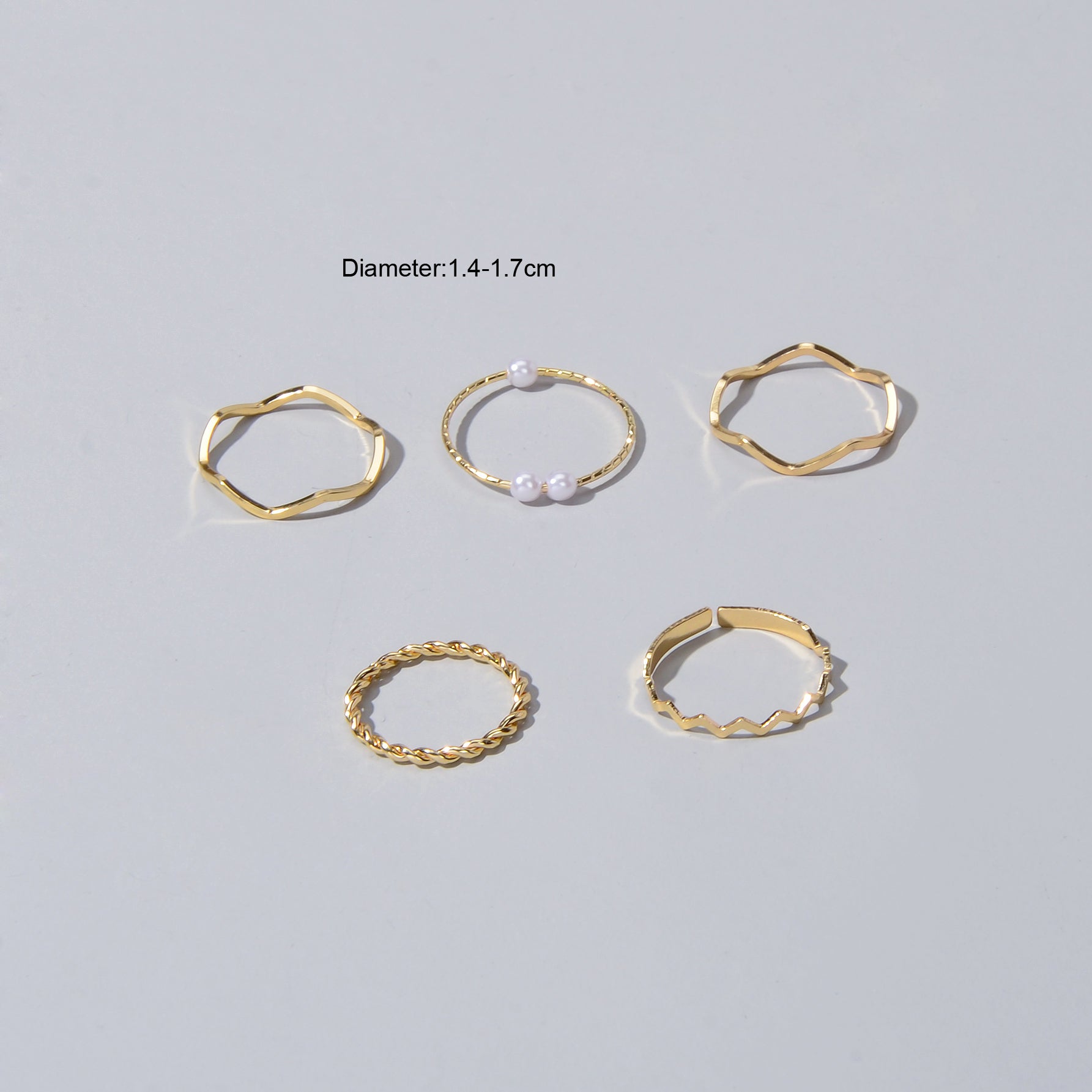5 piece stackable minimalist finger ring set in metal with elegant pearl accents — view 4