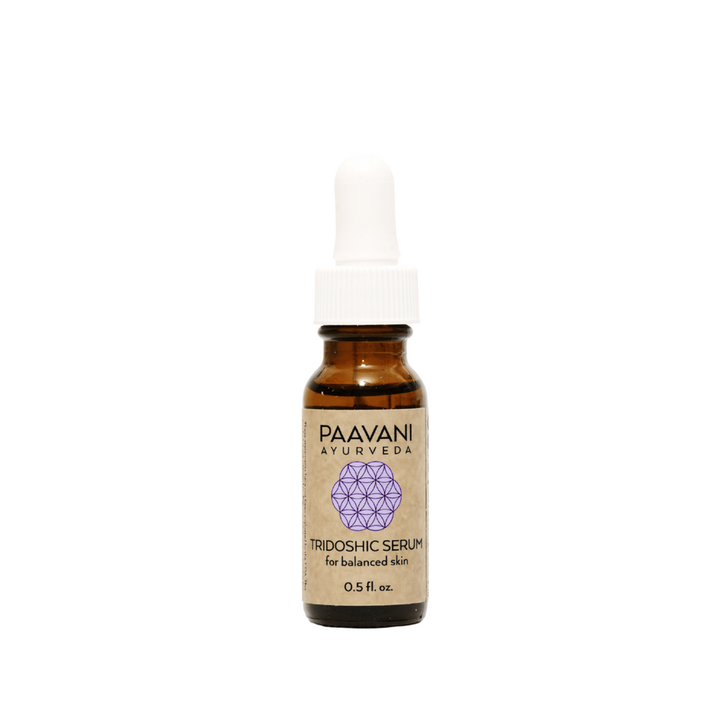 Tridoshic face serum in an earth-friendly amber glass bottle with a dropper cap