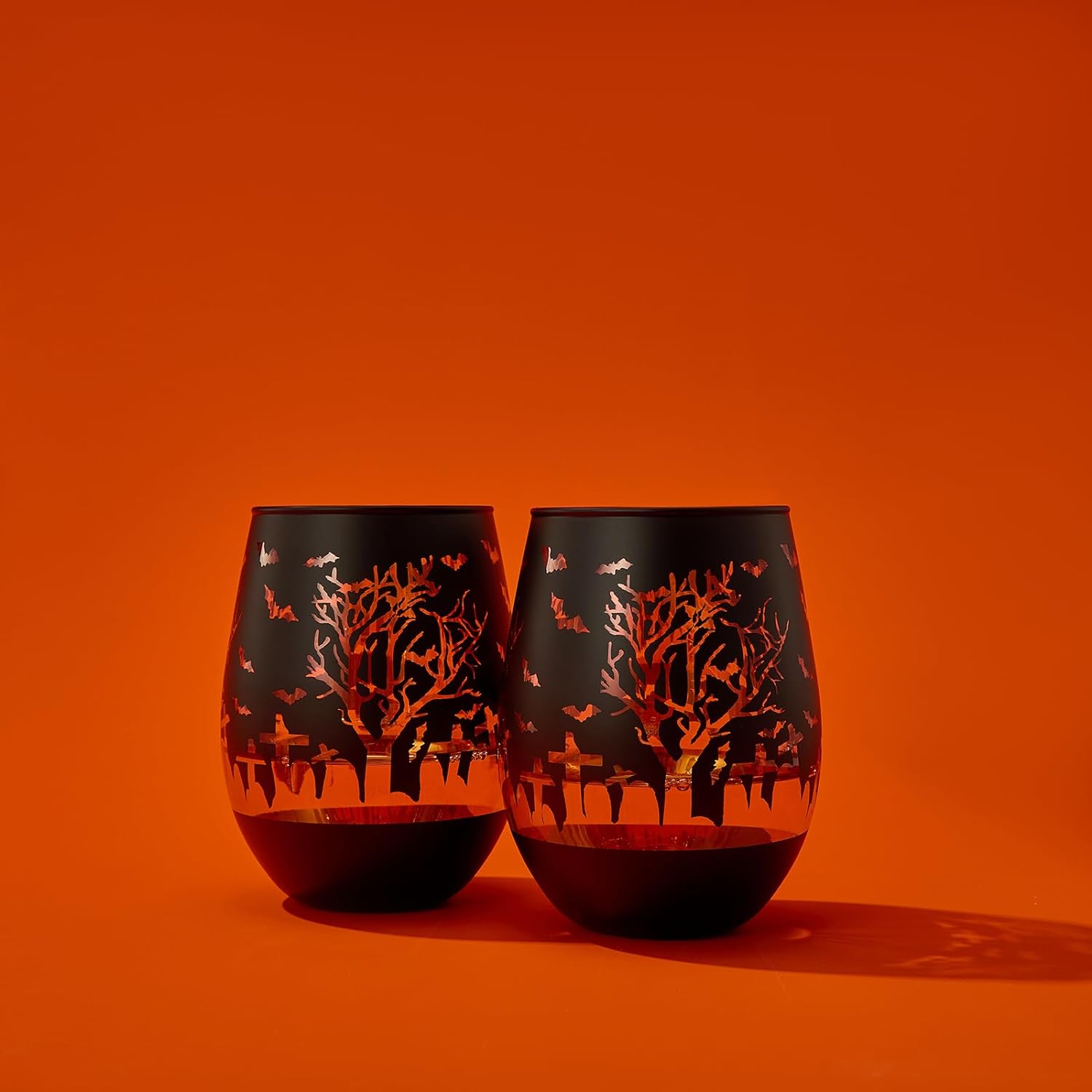 Set of two frosted black stemless wine glasses with gold interiors and spooky graveyard silhouettes — view 2
