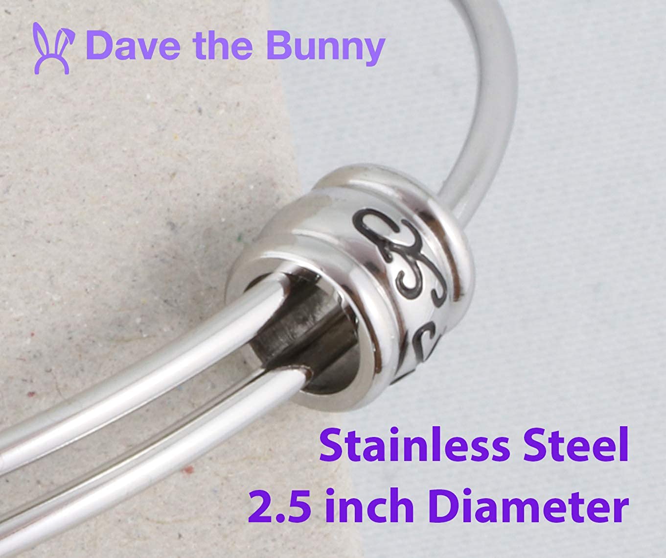 Stainless steel Saint Benedict medal snake chain charm bracelet on a neutral background — view 4