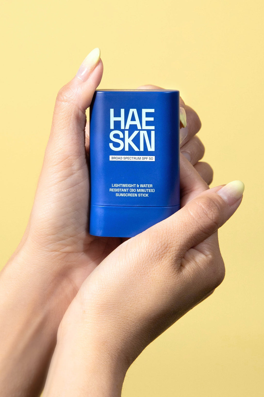 HAESKN SPF 50 sunscreen stick in a sleek, portable container for easy daily application. — view 2