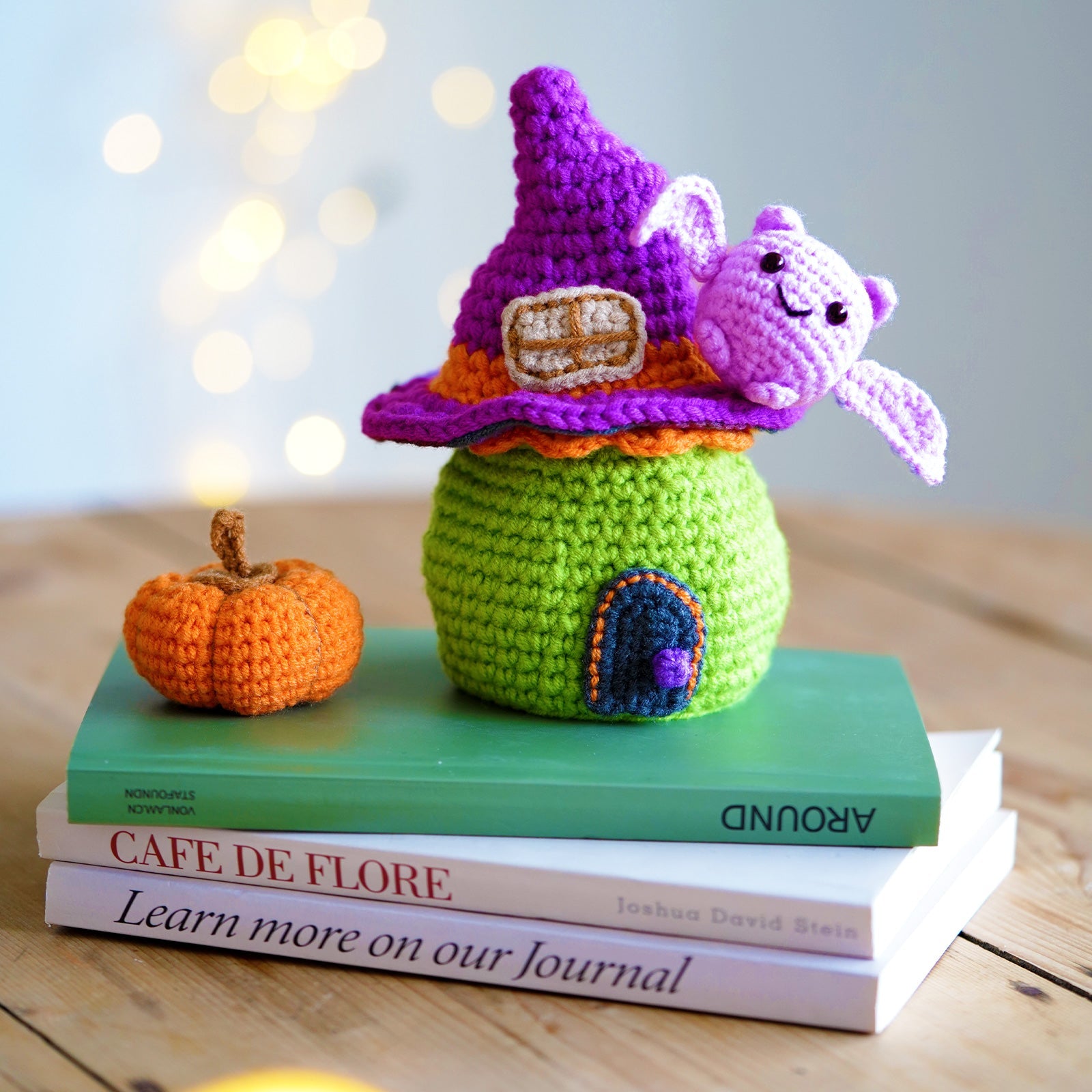 Halloween amigurumi DIY crochet kit featuring a completed miniature witch house, flying bat, and pumpkin