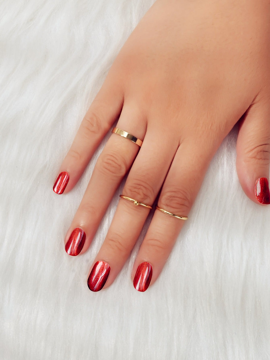 Minimalist gold stackable ring set featuring three polished metal bands arranged gracefully together — view 5