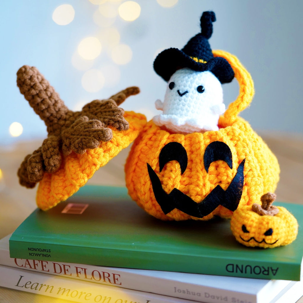 Halloween amigurumi crochet kit featuring a finished yarn pumpkin and cute little ghost plush figures