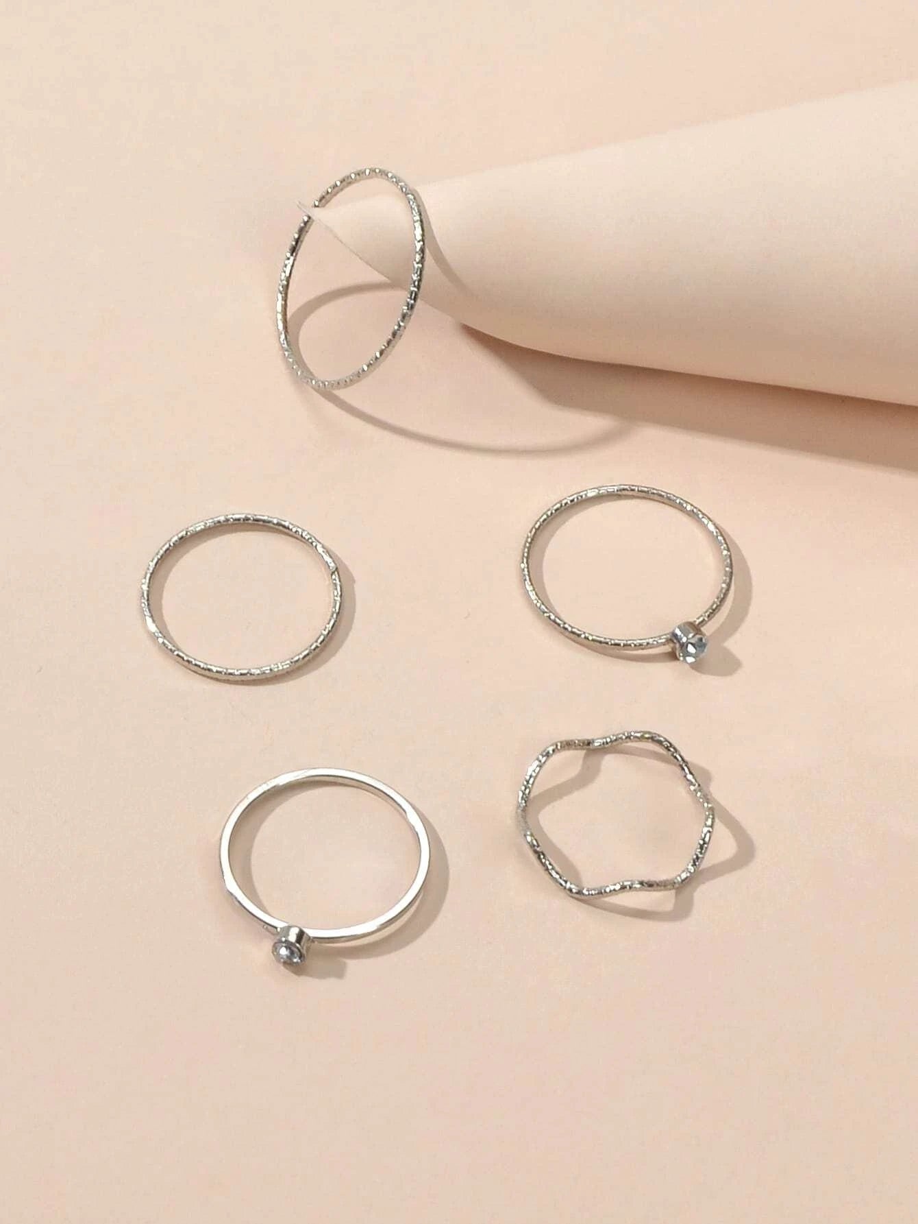 Silver double layer star pendant necklace and five matching knuckle rings displayed together as a set — view 5