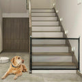 Portable mesh pet gate in black nylon fabric with stainless steel poles installed in a doorway