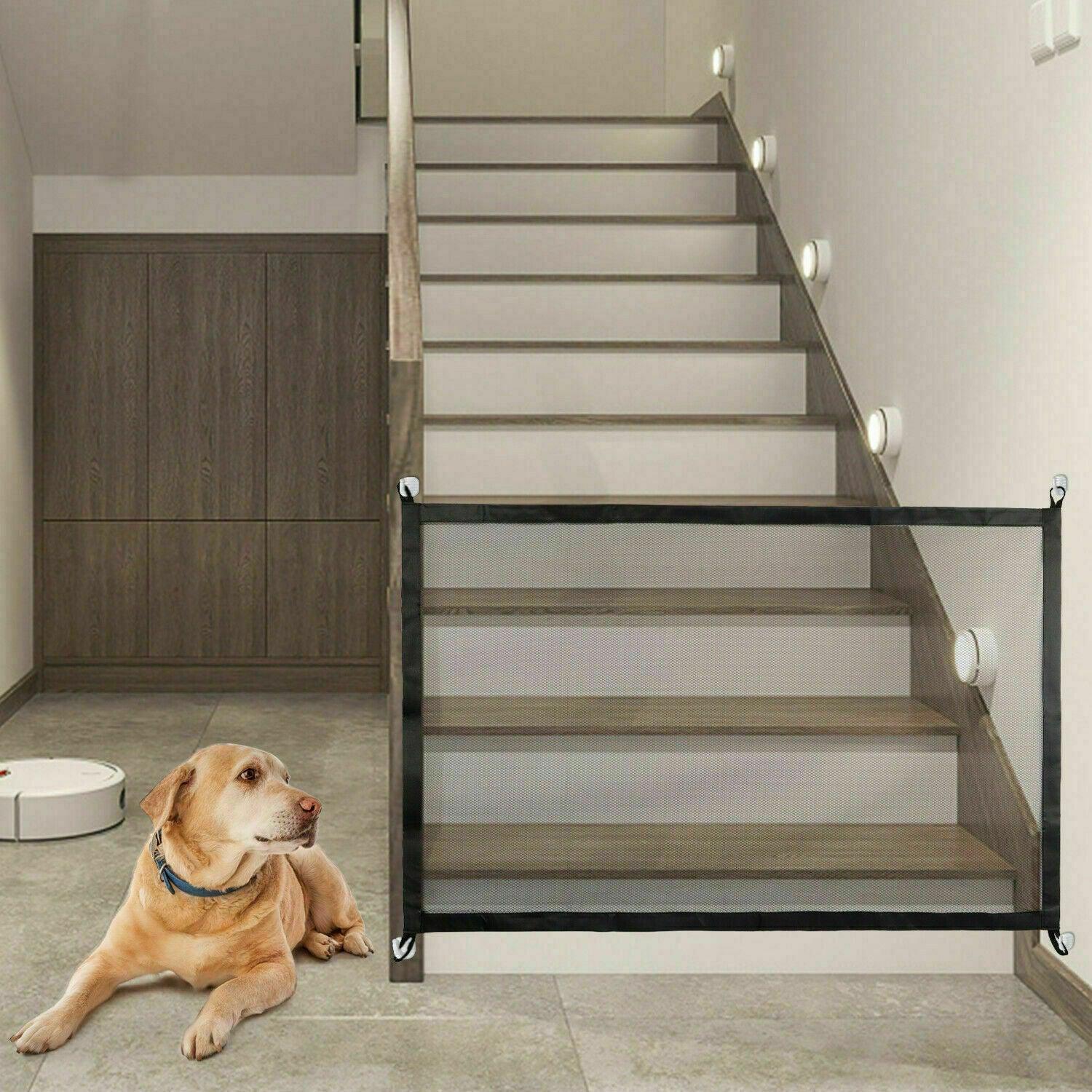 Portable mesh pet gate in black nylon fabric with stainless steel poles installed in a doorway