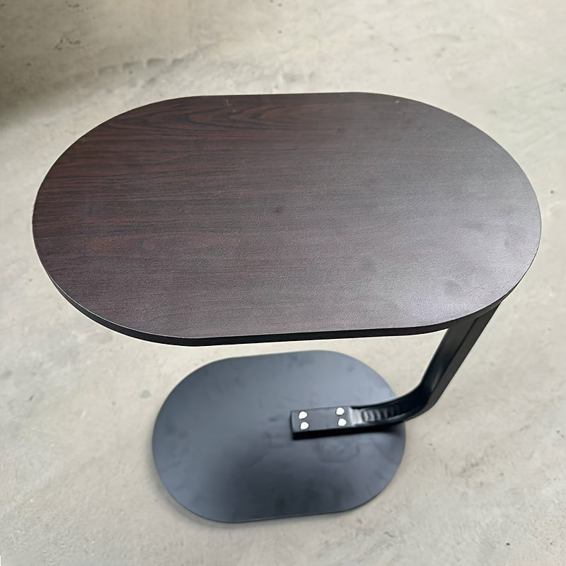 Nut-brown C-shaped side table with sleek metal frame in a modern living room setting. — view 5