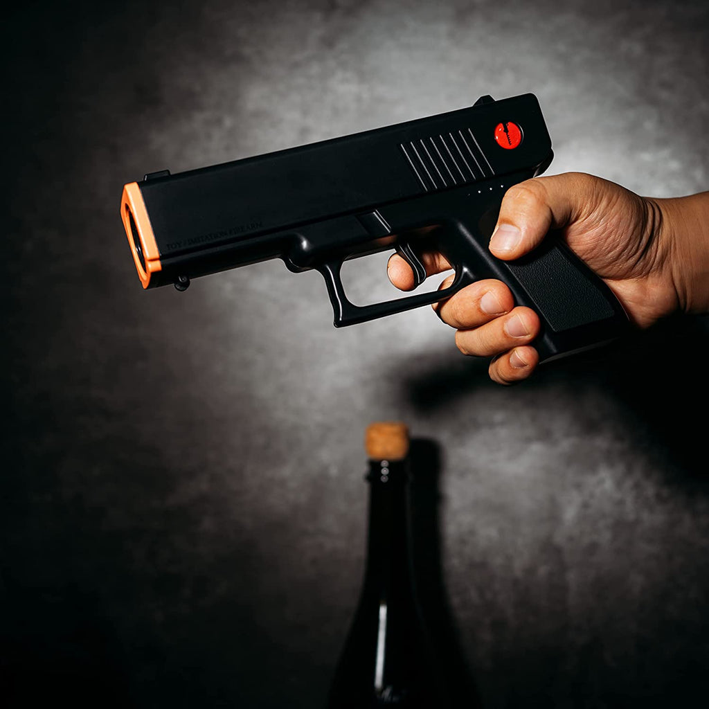 Black electric pistol shaped wine bottle opener resting in its rechargeable holster base. — view 4