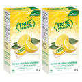 True Lemon water enhancer packets in dispenser boxes with fresh natural lemon wedges on display