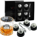 Stainless steel golf ball shaped whiskey stones chilling in a crystal glass of bourbon