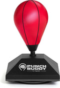 Mini desktop punching bag with suction cup base attached to an office desk for stress relief