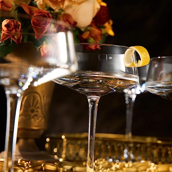 Four luxury glass martini coupes with an elegant silver mixing spoon for cocktail entertaining — view 3