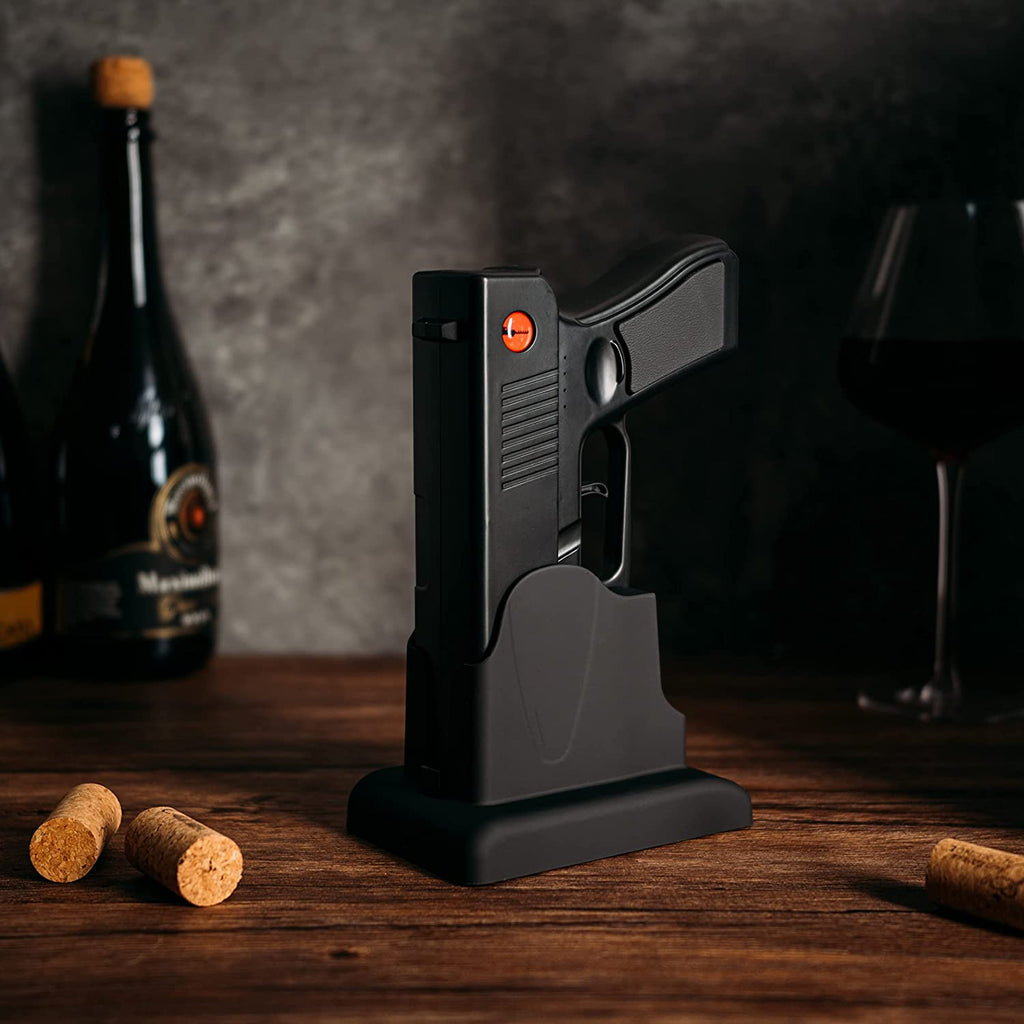 Black electric pistol shaped wine bottle opener resting in its rechargeable holster base. — view 2