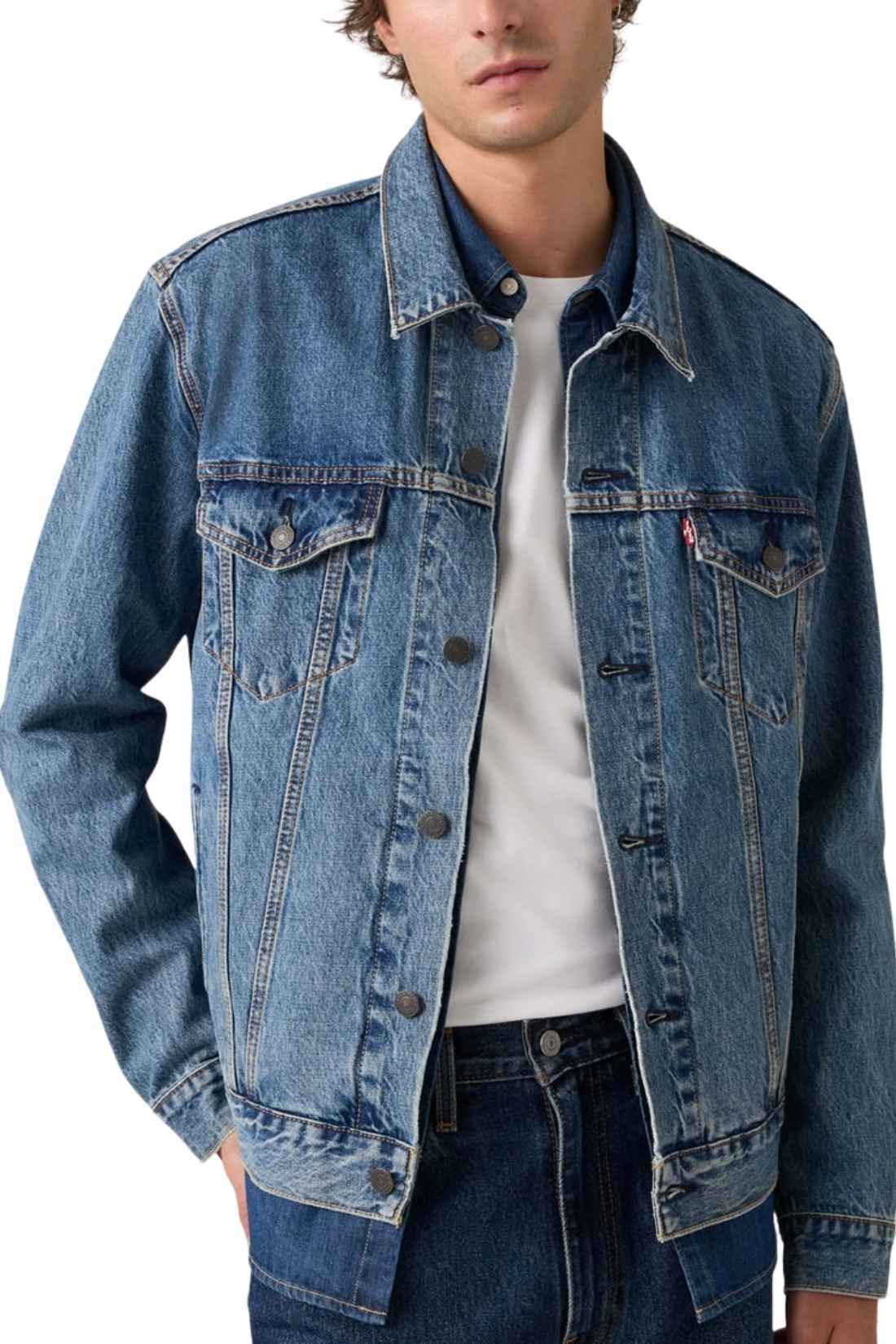 Men's classic medium wash denim trucker jacket featuring front logo buttons and chest flap pockets. — view 15