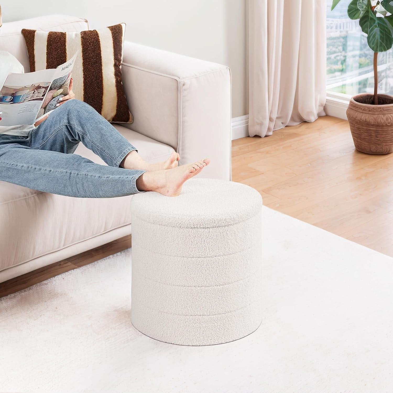 Round white velvet storage ottoman with flippable wooden tray top used as a coffee table — view 2