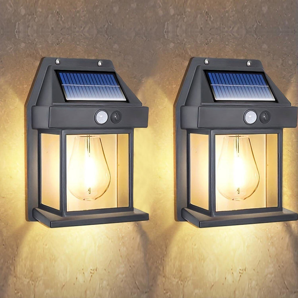 Two black plastic solar motion sensor LED outdoor security lights mounted on a wall — view 2